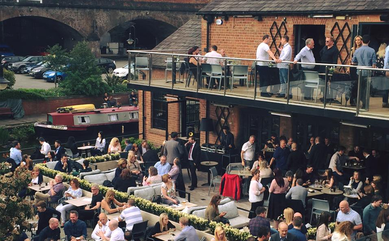 Dukes 92 outdoor area in Manchester with drinkers enjoying social time in the sun