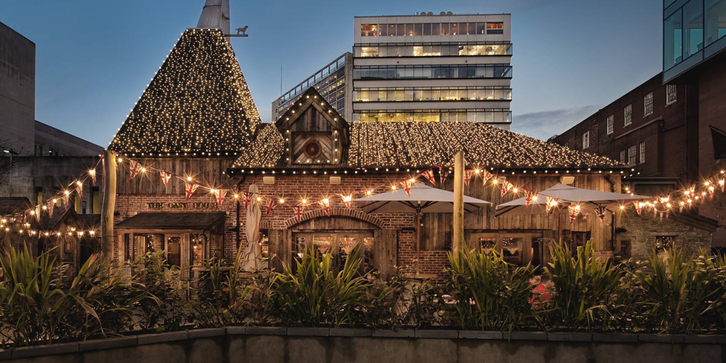 Oast House bar in Manchester's outdoor seating with lights and umbrellas